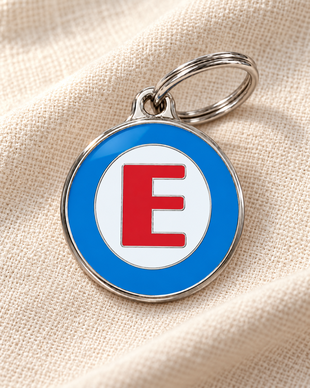TAGiDOG letter E dog ID tag on light linen
