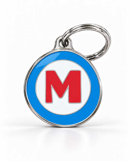 TAGiDOG letter M dog ID tag, round front view on white