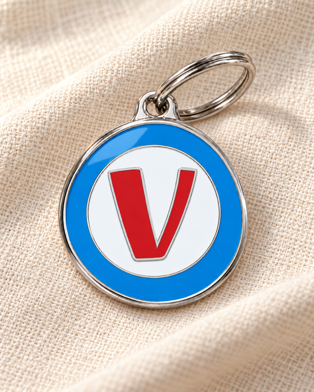 TAGiDOG letter V dog ID tag on light linen