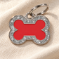 TAGiDOG Bone Spark Red ID Tag dog ID tag on light linen