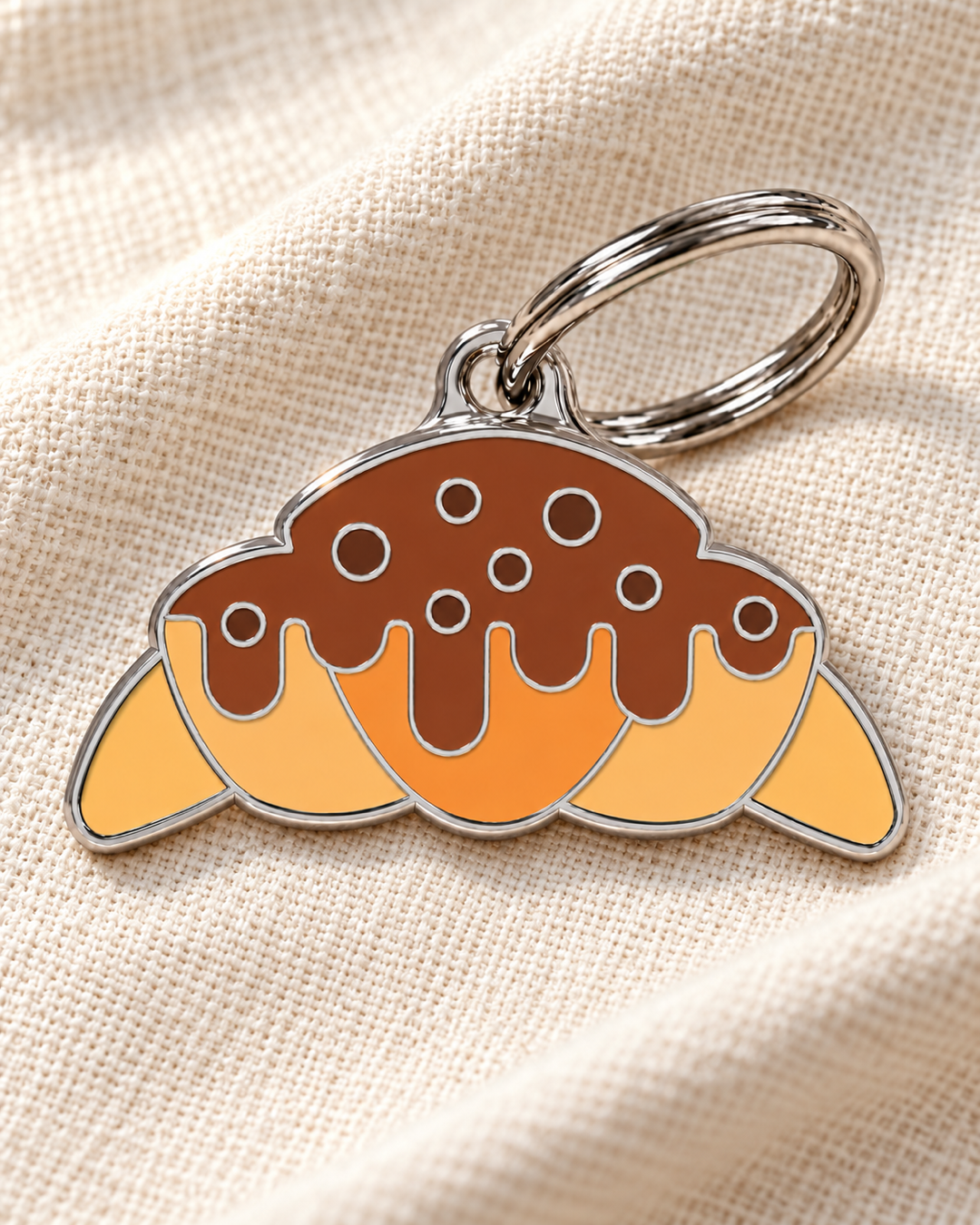 TAGiDOG Choco Drizzle Croissant ID Tag dog ID tag on light linen