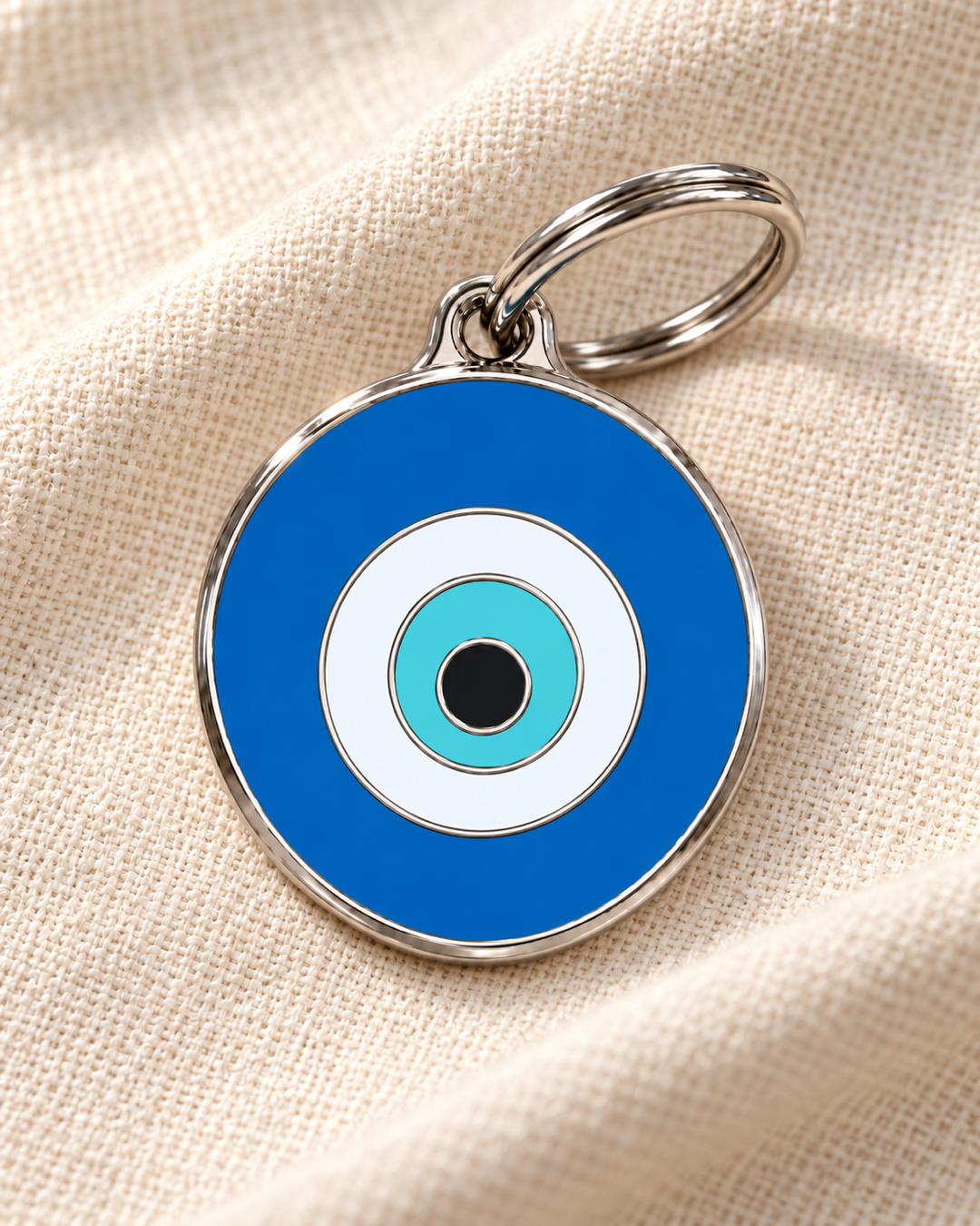 TAGiDOG Emoji Evil Eye dog ID tag on light linen