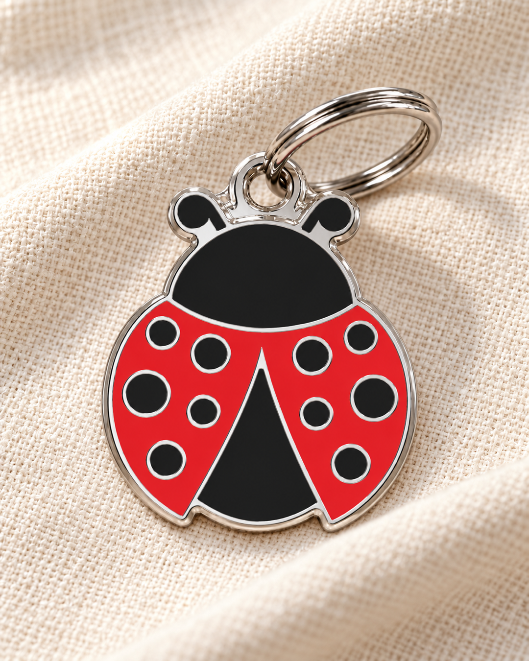 TAGiDOG Emoji Lucky Bug dog ID tag on light linen