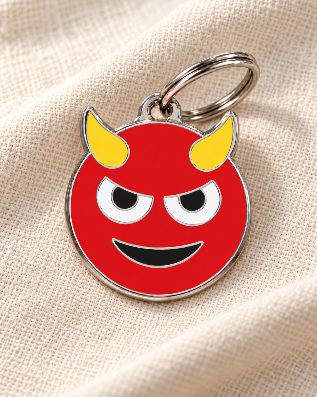 TAGiDOG Emoji Mischief dog ID tag on light linen