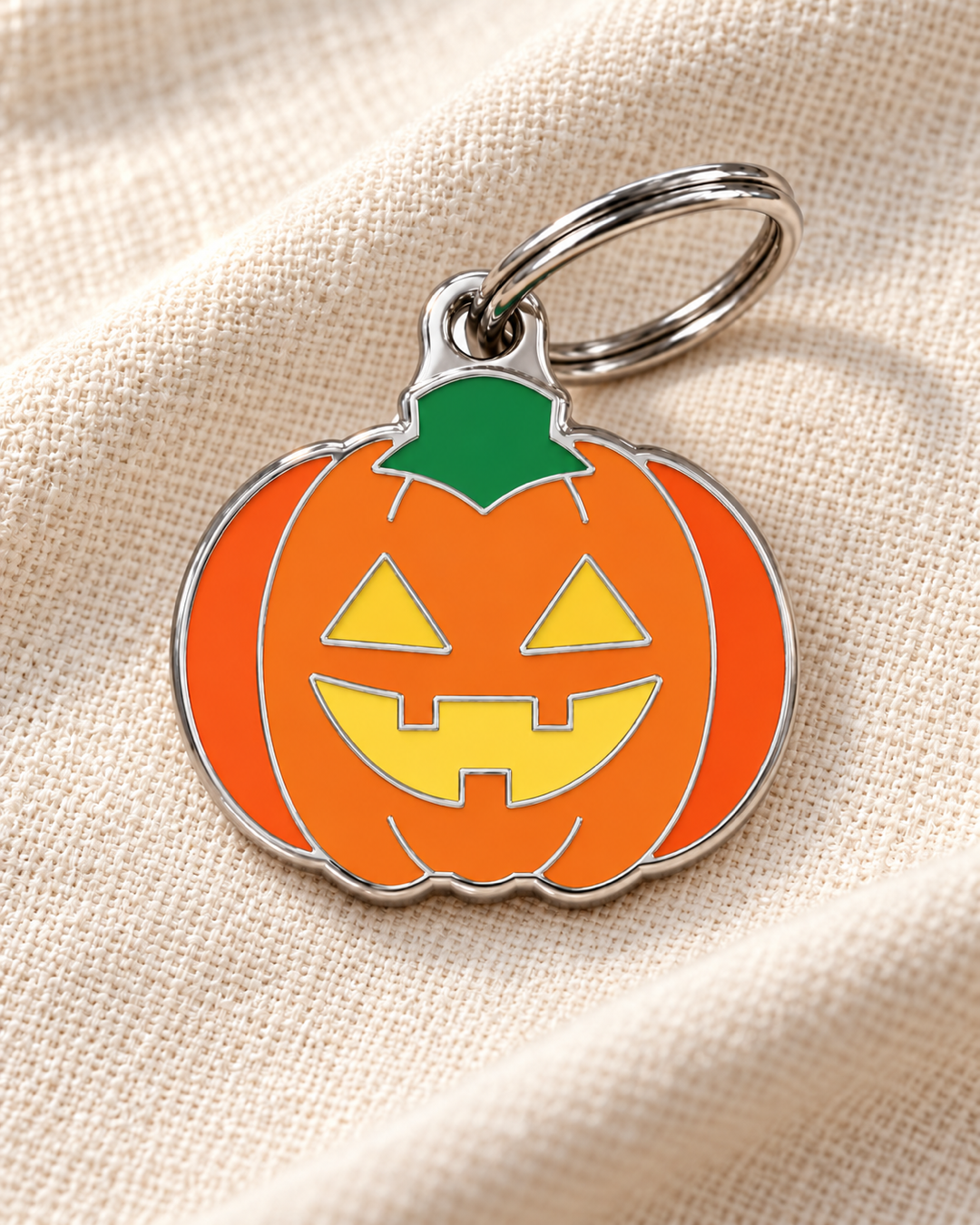 TAGiDOG Emoji Spooky Pumpkin dog ID tag on light linen